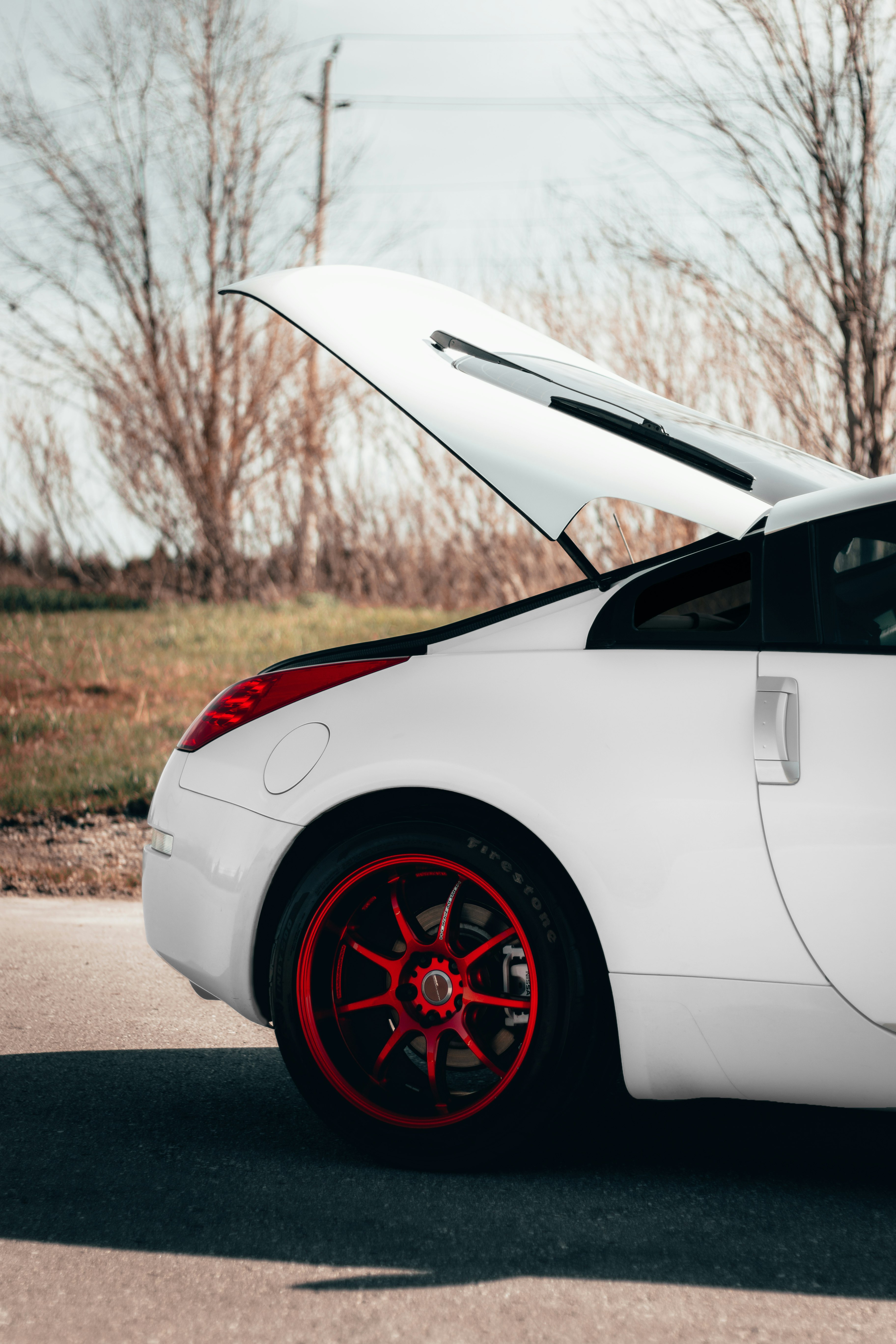 white coupe on road during daytime